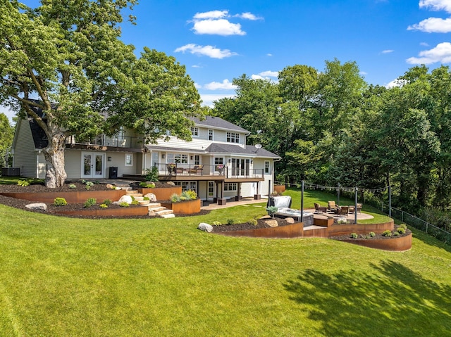 back of house with a patio, a deck, french doors, and a yard