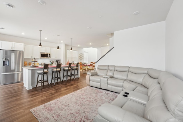 living room with recessed lighting, dark wood-style flooring, and visible vents