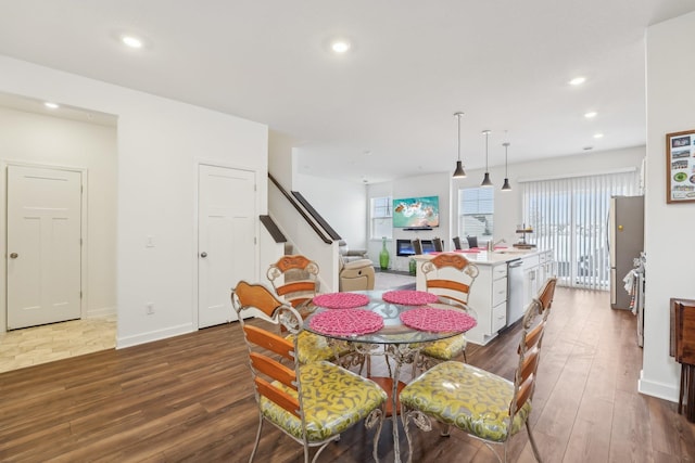 dining room with dark wood-style floors, stairway, baseboards, and recessed lighting