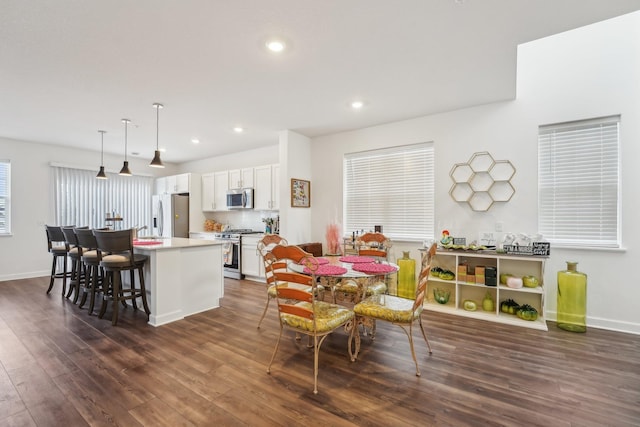 dining room with dark wood-style floors, baseboards, and recessed lighting