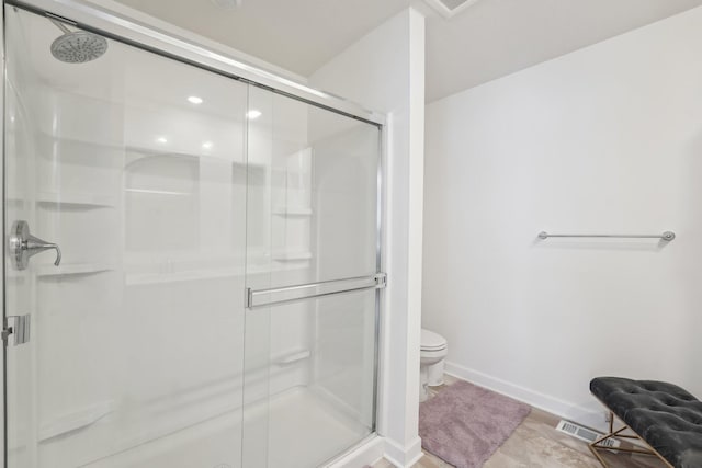 bathroom with toilet, a shower stall, visible vents, and baseboards