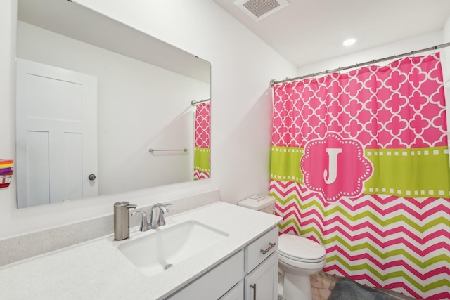 bathroom featuring toilet, curtained shower, vanity, and visible vents