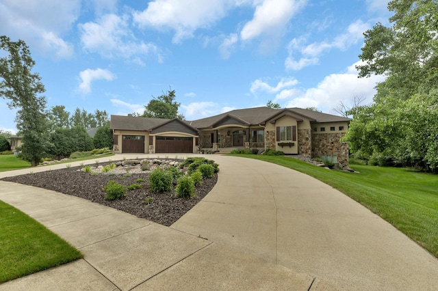 view of front of property with a garage, stone siding, concrete driveway, and a front yard