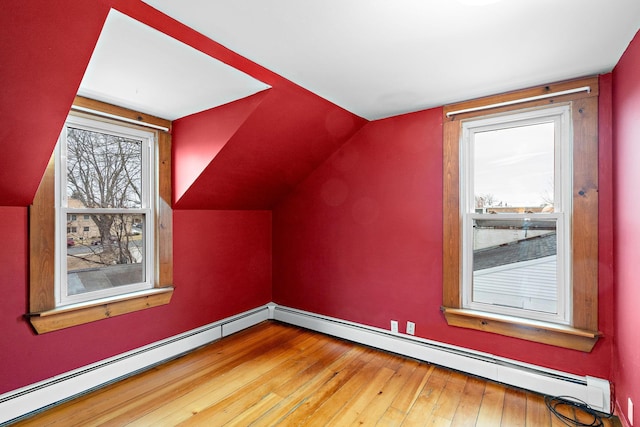 additional living space featuring lofted ceiling and hardwood / wood-style flooring