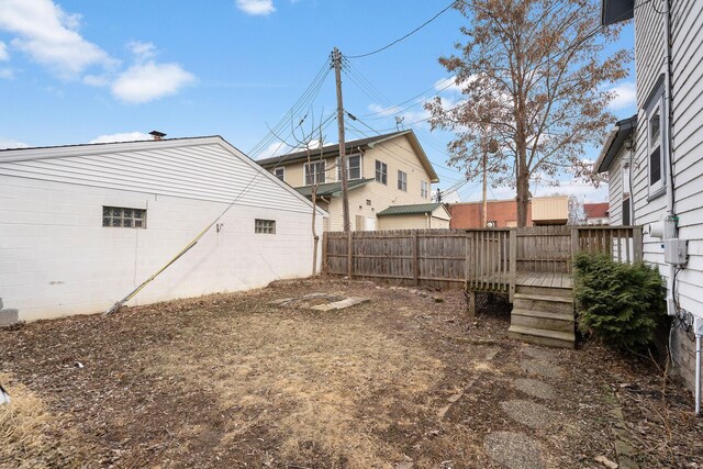 view of yard featuring fence and a deck