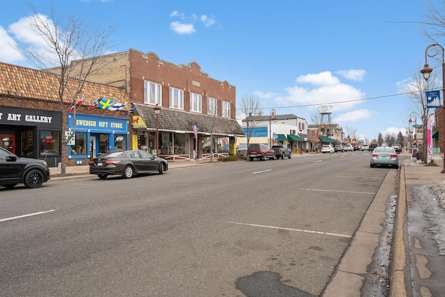 view of road with street lighting, curbs, and sidewalks