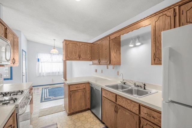 kitchen with white appliances, light floors, brown cabinets, and a sink