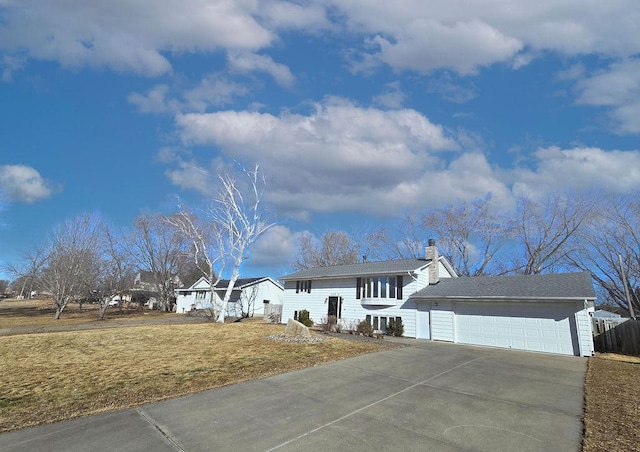 view of front facade featuring concrete driveway, a chimney, an attached garage, fence, and a front yard