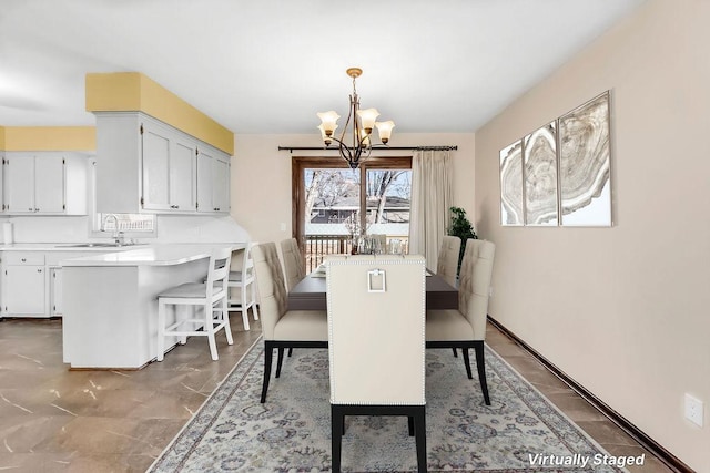 dining area featuring baseboards and an inviting chandelier