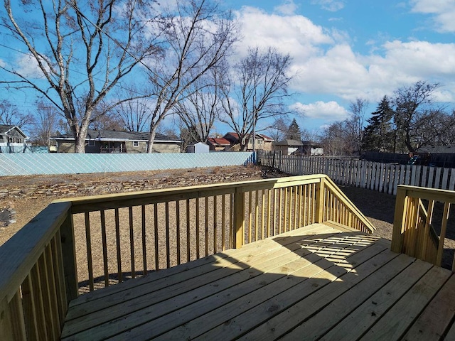 wooden terrace featuring a fenced backyard