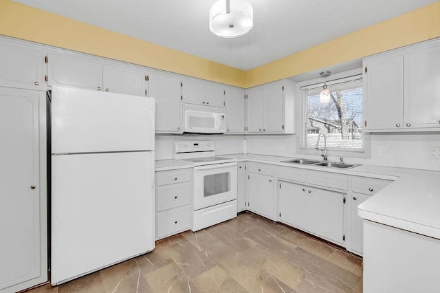 kitchen featuring light countertops, white appliances, white cabinetry, and a sink