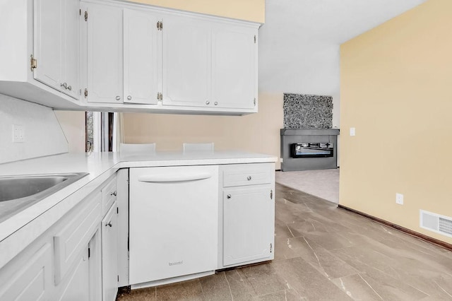 kitchen with light countertops, visible vents, dishwasher, and white cabinetry