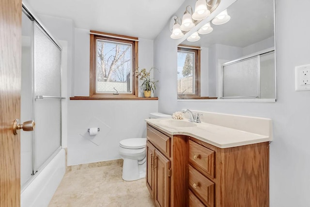 bathroom with toilet, enclosed tub / shower combo, baseboards, and vanity