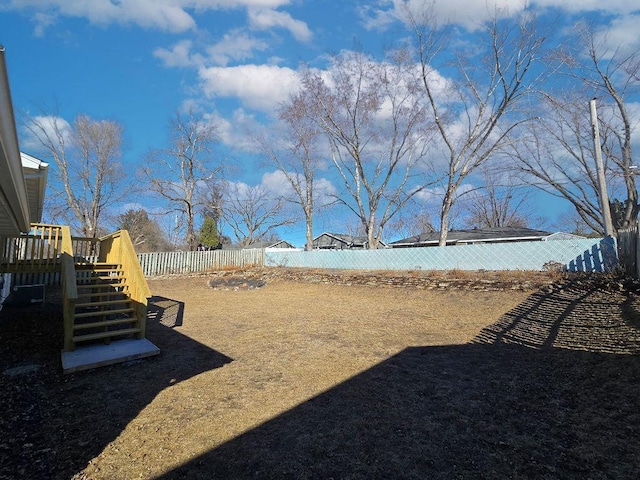 view of yard featuring a fenced backyard and a deck