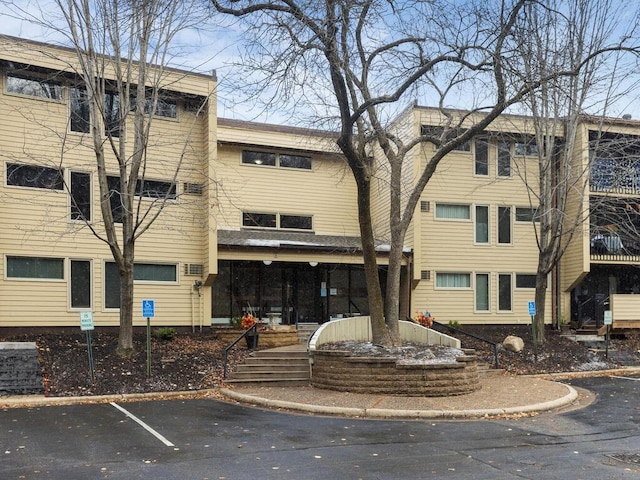 view of property featuring uncovered parking