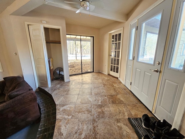 21888 650th Ave, Dexter, MN 55926 - entrance foyer with healthy amount of natural light, a ceiling fan, beamed ceiling, and light stone finish floors