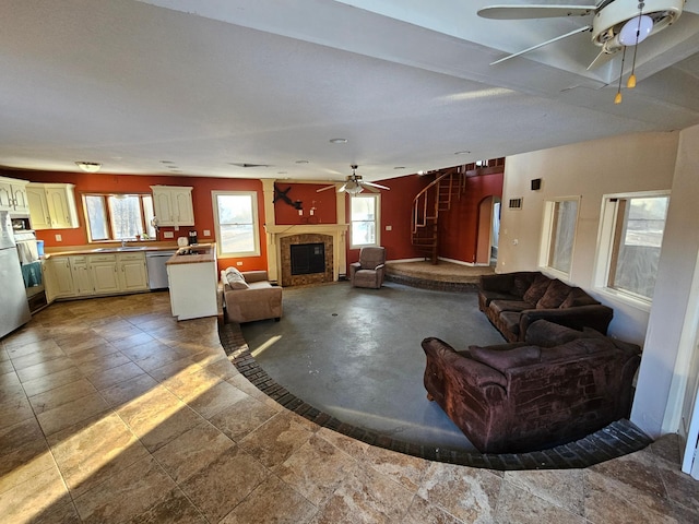 21888 650th Ave, Dexter, MN 55926 - living area with ceiling fan, a fireplace, and stairway