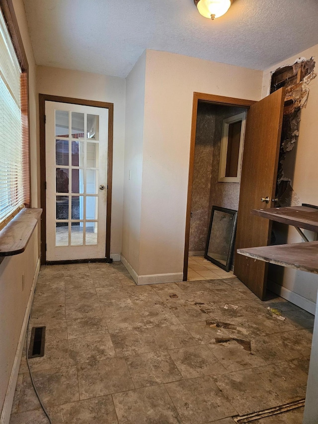 21888 650th Ave, Dexter, MN 55926 - unfurnished dining area with baseboards and a textured ceiling