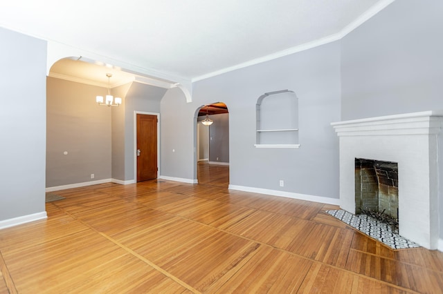 unfurnished living room featuring baseboards, a fireplace, arched walkways, and ornamental molding