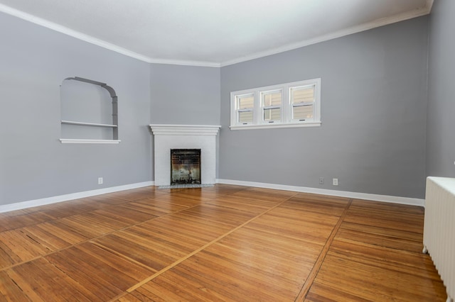 unfurnished living room featuring a fireplace with flush hearth, radiator heating unit, baseboards, and ornamental molding