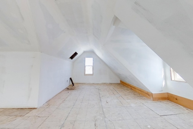 additional living space featuring vaulted ceiling