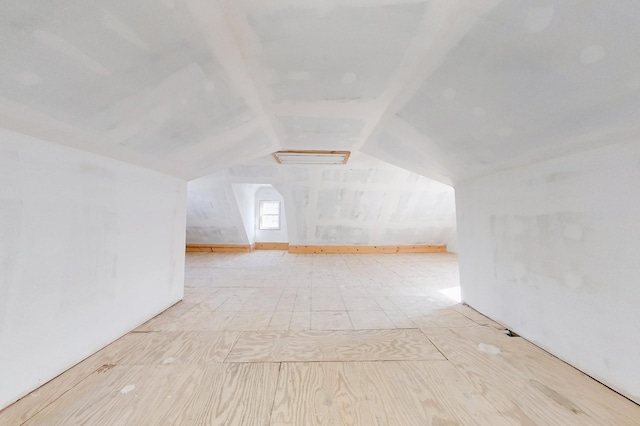 additional living space featuring vaulted ceiling