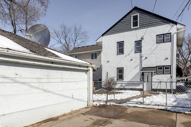 exterior space with fence and stucco siding