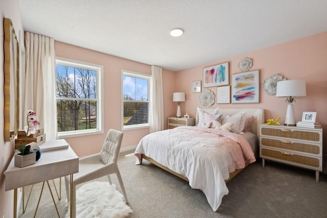 bedroom featuring carpet and baseboards