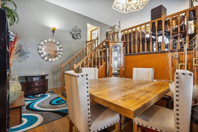 dining room featuring stairs, a chandelier, and wood finished floors