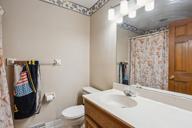 bathroom featuring curtained shower, vanity, and toilet