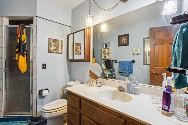 bathroom with toilet, a stall shower, and vanity