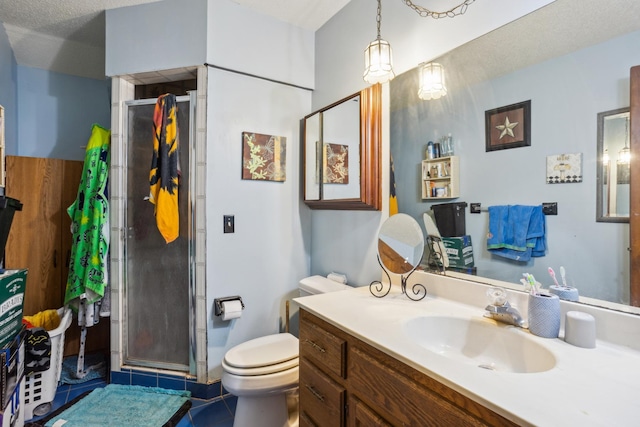 full bathroom featuring vanity, a stall shower, tile patterned flooring, and toilet