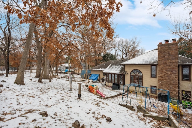 yard layered in snow with central AC unit and fence