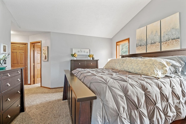 bedroom with carpet floors, baseboards, and vaulted ceiling