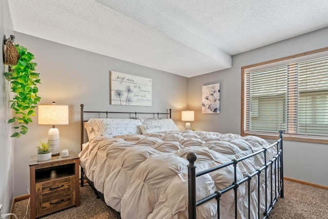 bedroom with carpet floors, a textured ceiling, and baseboards