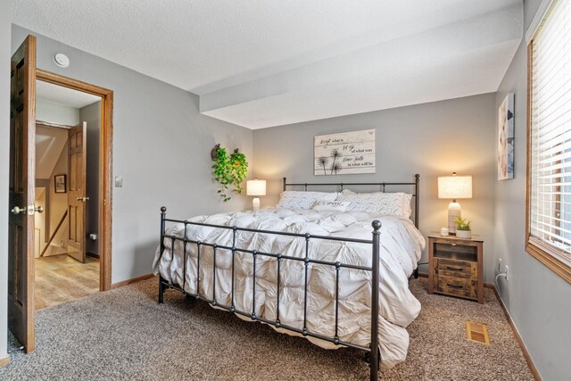 carpeted bedroom with baseboards and visible vents