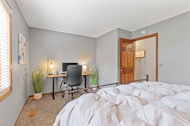 bedroom with visible vents, carpet, and baseboards