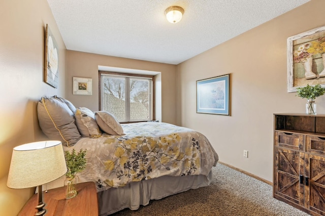 carpeted bedroom featuring a textured ceiling and baseboards