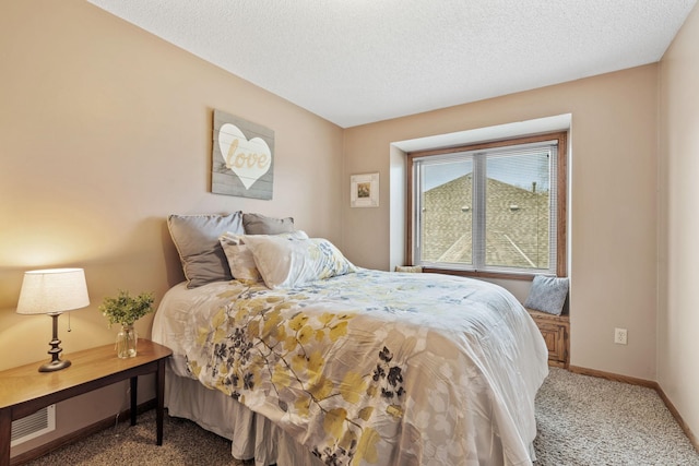 carpeted bedroom featuring baseboards, a textured ceiling, and visible vents
