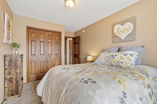 carpeted bedroom with a closet and a textured ceiling