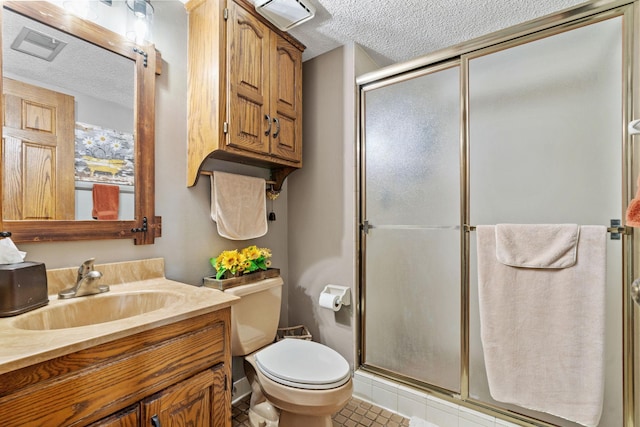 full bath with tile patterned floors, a shower stall, toilet, and a textured ceiling