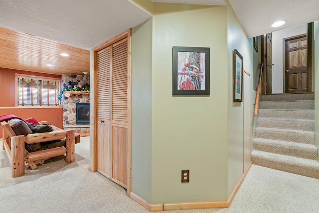 hallway featuring recessed lighting, carpet floors, and stairs