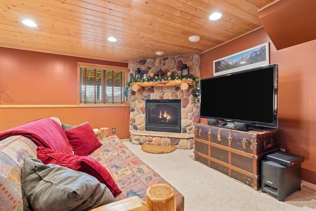 carpeted living area featuring recessed lighting, a stone fireplace, and wooden ceiling