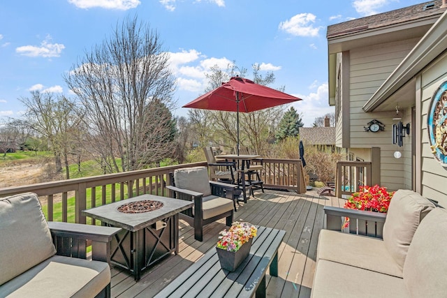 wooden deck with a fire pit