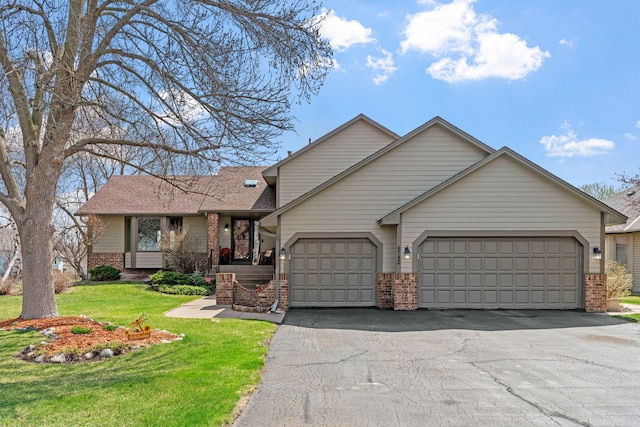 ranch-style home with a garage, a front lawn, brick siding, a shingled roof, and driveway