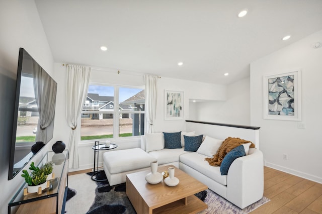 living area featuring baseboards, wood-type flooring, and recessed lighting