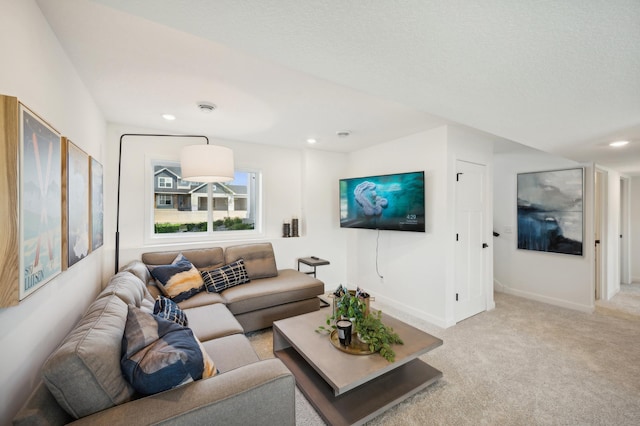 living room featuring baseboards, recessed lighting, and light colored carpet