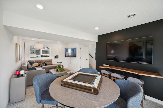 dining area featuring carpet, stairway, and recessed lighting