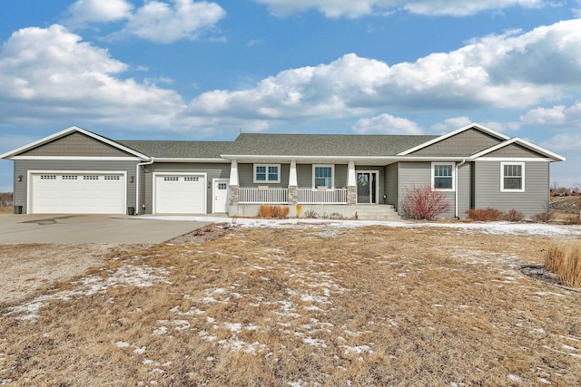 ranch-style house with a porch, an attached garage, and concrete driveway