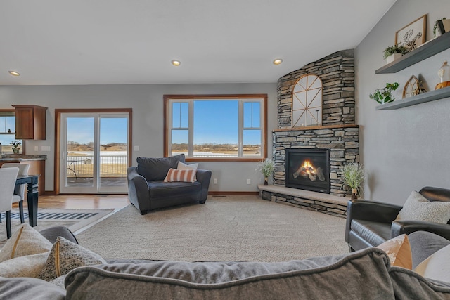 living room with light colored carpet, recessed lighting, a fireplace, and baseboards